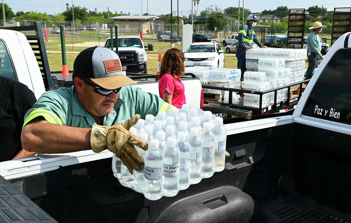 City of Laredo Parks and Recreation crew member Federico Cruz helps load cases of bottled water in response to a boil water notice Monday, July 5, 2021, during a water distribution at Independence Hills Regional Park.