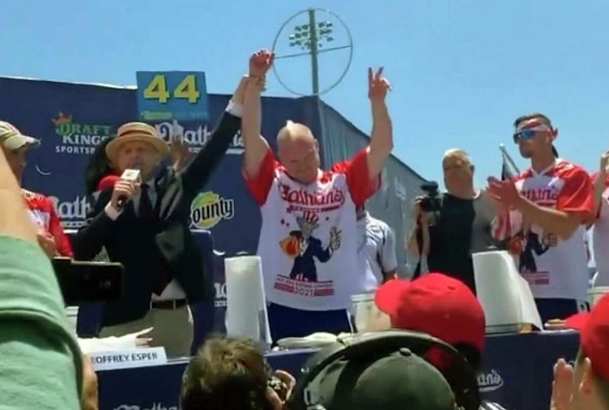 Nicholas Wehry, center, a Connecticut native, came in third at the annual Nathan's Hot Dog Eating Contest in New York on Sunday, July 4, 2021.