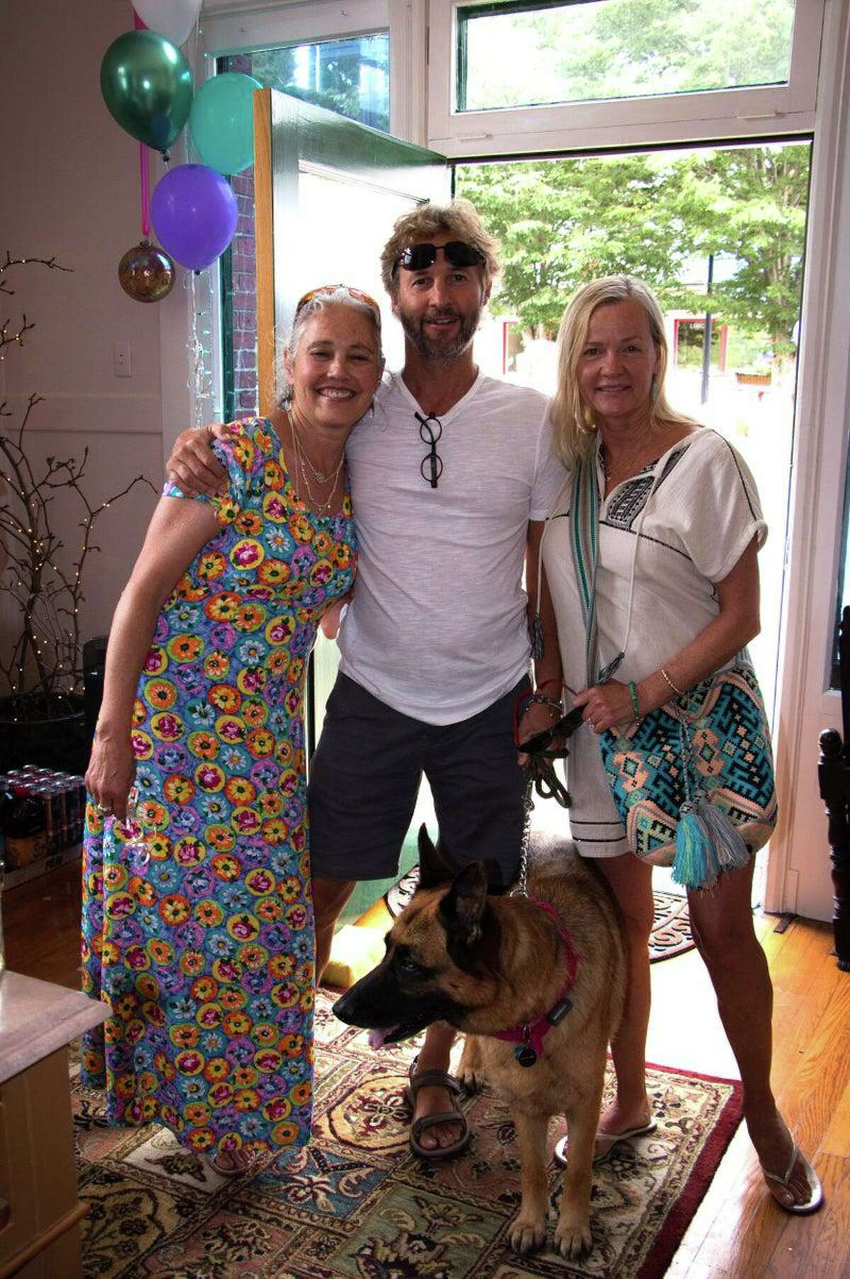 Healing Nest, a new wellness center, opened June 26 in Norfolk. From left are owner Dianna Hofer, her brother David Mullane and his wife, Kristin Scott, with their dog Lua.