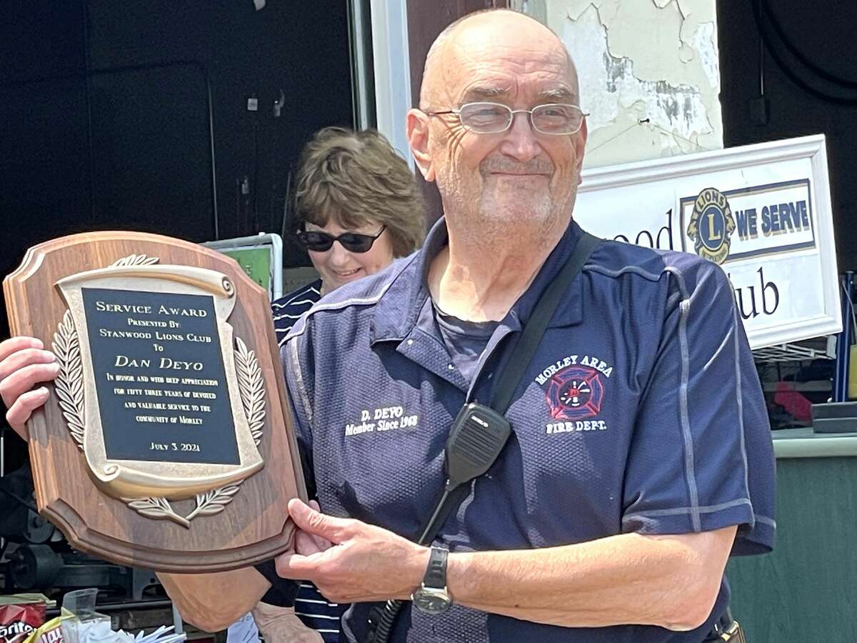 Members of the Stanwood Lions Club honored Dan Deyo with a service award plaque for 53 years of service with the Morley Area Fire Department.