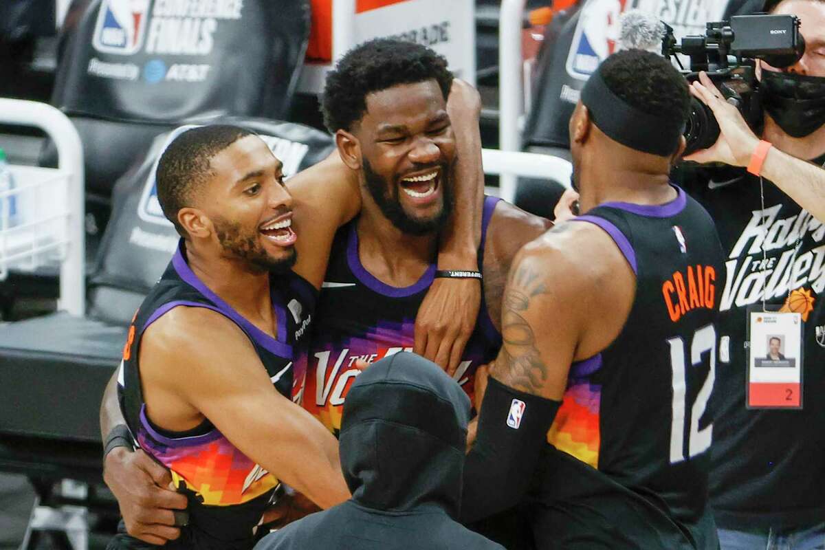 *** BESTPIX *** PHOENIX, ARIZONA - JUNE 22: Deandre Ayton #22 of the Phoenix Suns, Torrey Craig #12, and Mikal Bridges #25 celebrate defeating the LA Clippers 104-103 in game two of the NBA Western Conference finals at Phoenix Suns Arena on June 22, 2021 in Phoenix, Arizona. NOTE TO USER: User expressly acknowledges and agrees that, by downloading and or using this photograph, User is consenting to the terms and conditions of the Getty Images License Agreement. (Photo by Christian Petersen/Getty Images)