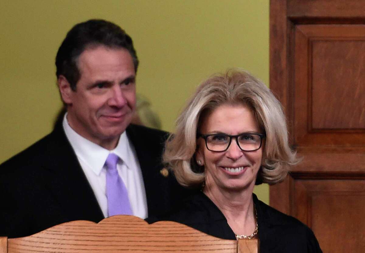 Judge Janet DiFiore enters the Court of Appeals chamber followed by Governor Andrew Cuomo before she was sworn in as the new Chief Judge of the New York State Court of Appeals Monday Feb. 8, 2016, in Albany, N.Y. (Skip Dickstein/Times Union)