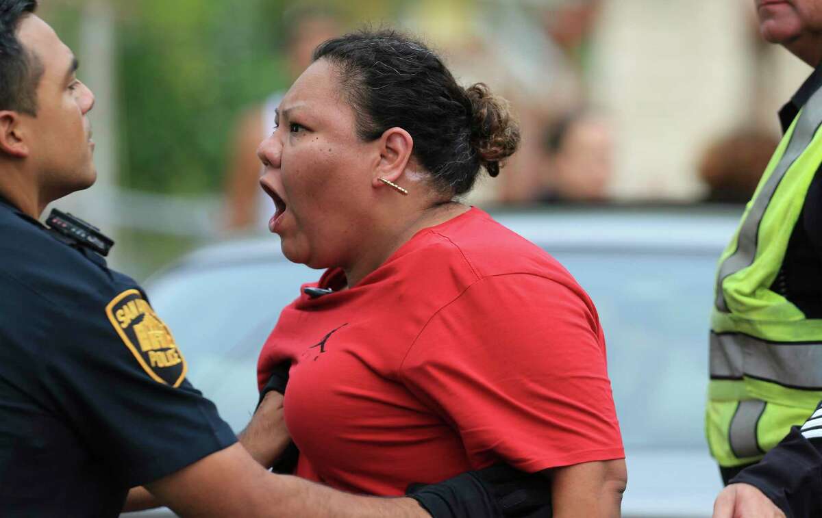 Tempers flare amongst family members after police were involved in a standoff with a man who fired shots at residents and at a KSAT television crew who were on the scene to follow up on an overnight fire incident on Monday, July 5, 2021. The man fled from the scene at the 200 block of Noria and police then surrounded him at another home on the 300 block of Noria. The suspect was killed during a shootout with five police officers during the standoff.