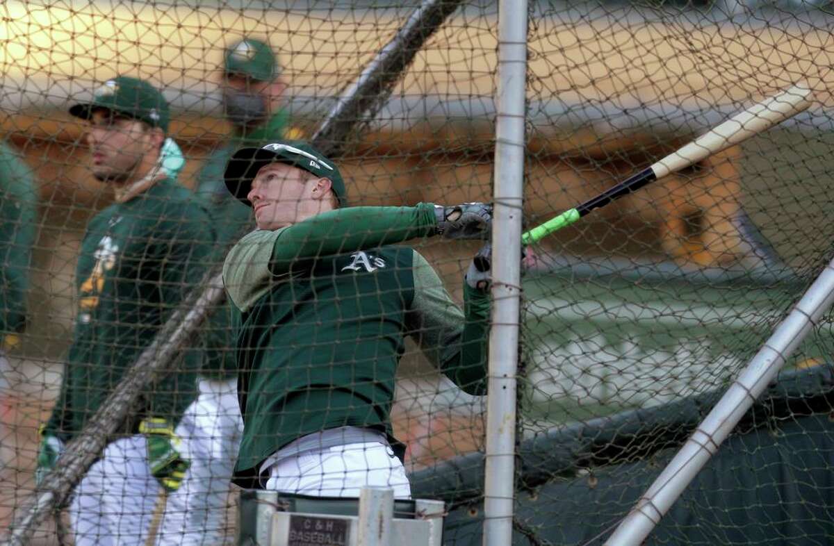 Mark Canha takes batting practice as the Oakland Athletics practiced at the Coliseum in Oakland, Calif., on Tuesday, July 14, 2020. The A’s are set to play two games against the Giants next week.