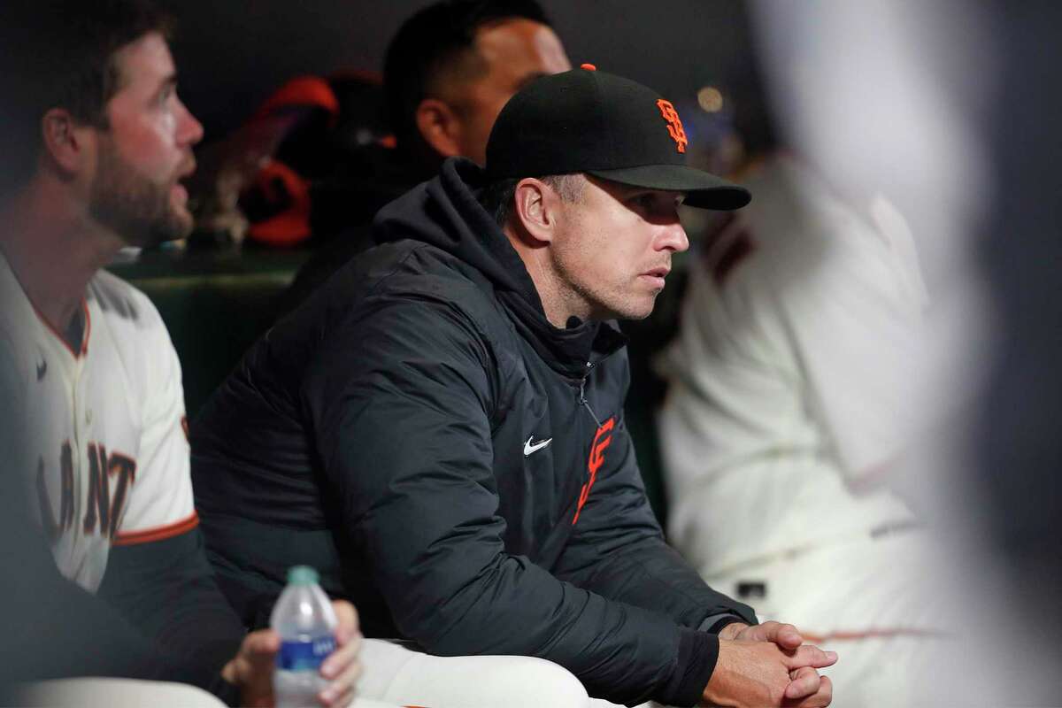 San Francisco Giants' Buster Posey watches from bench as Giants play St. Louis Cardinals during MLB game at Oracle Park in San Francisco, Calif., on Tuesday, July 6, 2021.