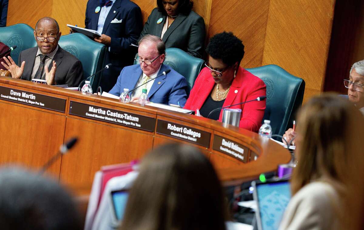 Mayor Sylvester Turner, left, talks to council members during the first in-person meeting in a year at City Hall on Wednesday, June 2, 2021, in Houston. City Council met to consider the mayor's $5.1 billion budget for the next fiscal year.