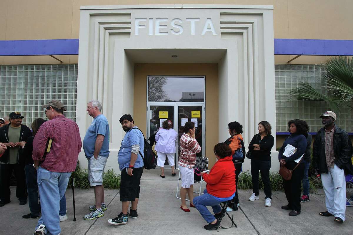 People wait in line to get tickets to Fiesta events at the Fiesta Store on Broadway in 2014.