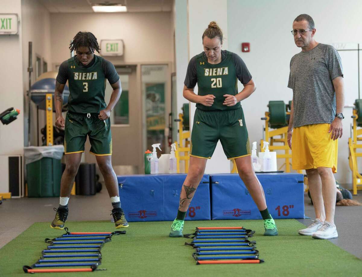 Head coach Jim Jabir, right, watches as Rayshel Brown, left, and Margo Peterson do a drill as Siena women's basketball holds summer workouts at Siena College on Wednesday, July 7, 2021, in Loudonville, N.Y. (Lori Van Buren/Times Union)