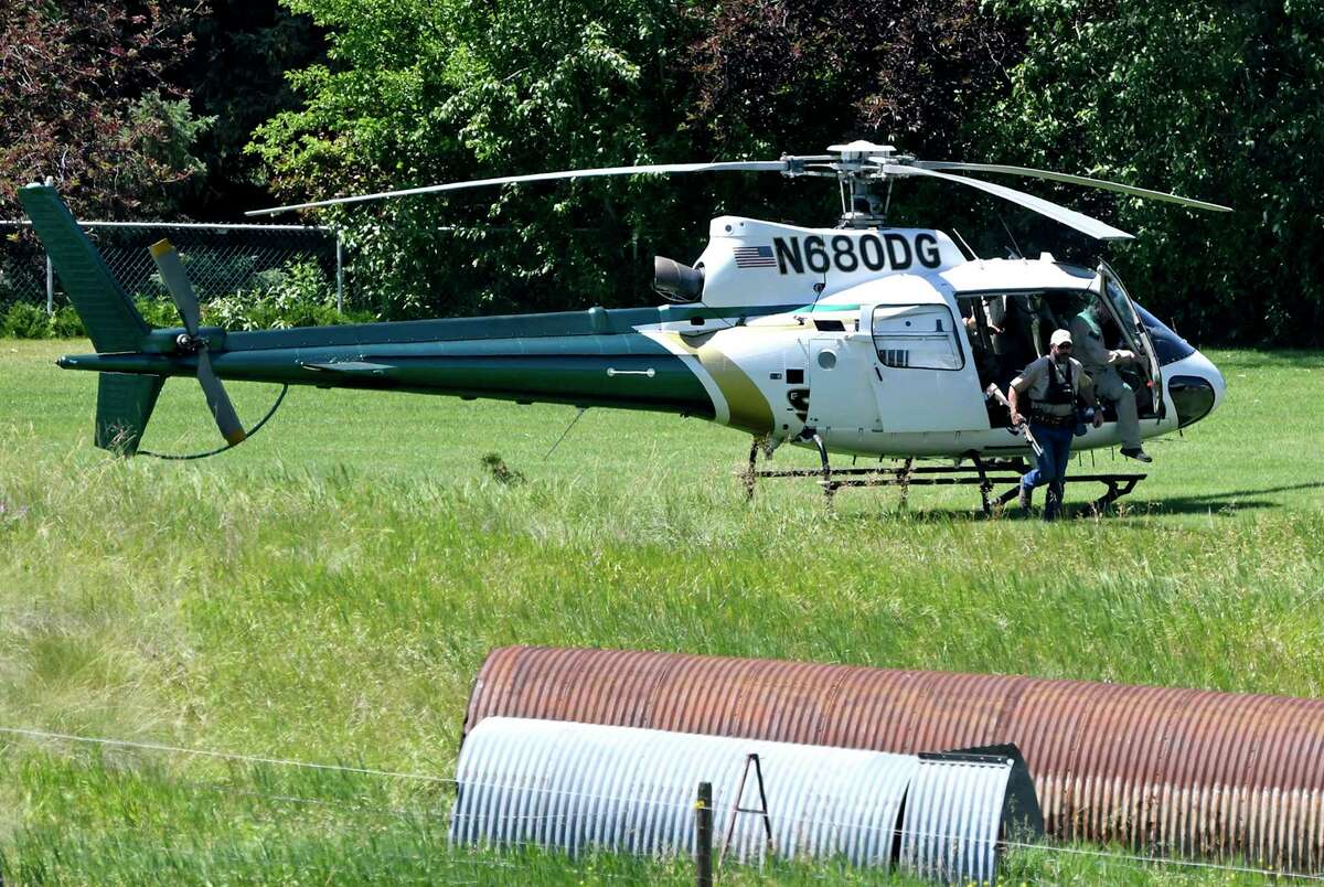 A Montana Department of Fish, Wildlife and Parks helicopter lands in Ovando, Mont., on Tuesday, July 6, 2021, after searching for a bear that killed a camper early that morning. The search for the bear continued Wednesday. (Tom Bauer/The Missoulian via AP)
