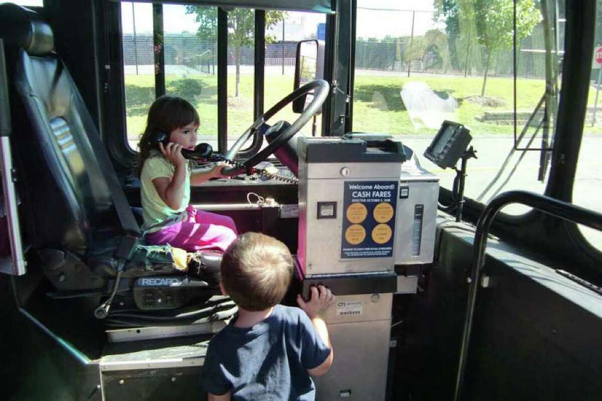 Will she waive the fare? Some youngsters hop aboard a Greater Bridgeport Tranist Authority bus last year during the Junior Women's Club of Fairfield's Touch-a-Truck event. This year, the club will bring it back to Fairfield on Sunday. It raises funds for its scholarship program.