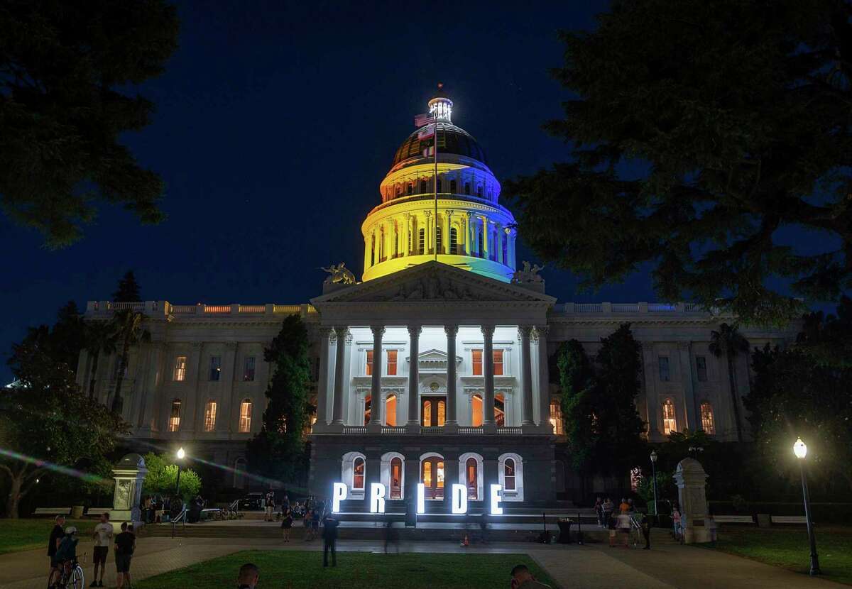 The California state Capitol in Sacramento is illuminated in rainbow colors to celebrate LGBT Pride month on June 21, 2021. California has reinstated a mask mandate for all legislators and employees at the Capitol regardless of vaccination status following an outbreak of nine COVID-19 cases there.