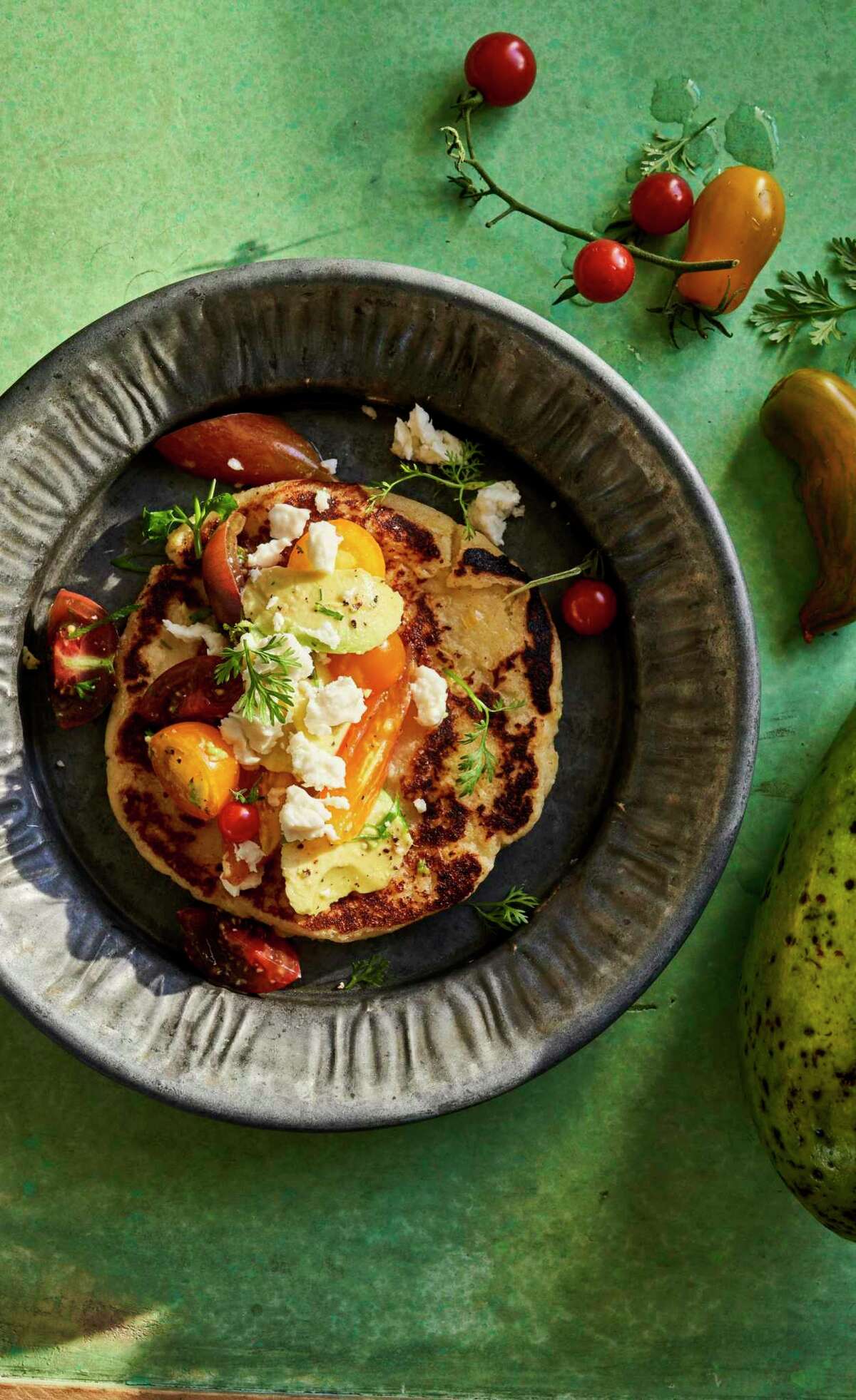 Arepa de Choclo, a sweet corn arepa loaded with cheese, from "Colombiana" by Mariana Velásquez (Harper Wave).