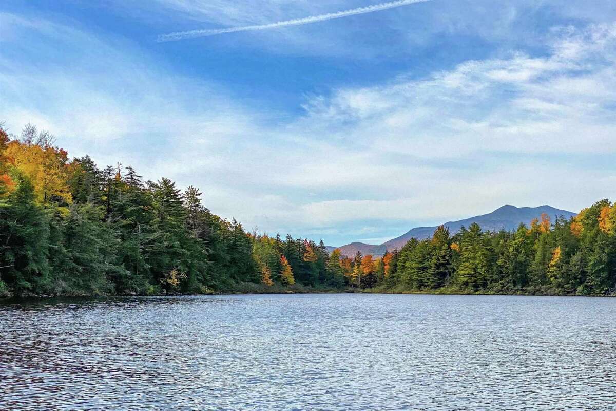 55 Red Fox La. Hague, NY PRICE: $2,200,000 DESCRIPTION: Four season waterfront home w/ 100' of shoreline in Arcady Bay on Northwestern Lake George. Captivating lake views, 2677sqft of living space, cathedral ceilings, 2-story 2-sided fireplace in the great room, 5BRs & 3 full BAs, lakeside screened porch & deck on main floor, lower level w/ family room, wood stove & bluestone patio. Lakeside patio steps down to a U-shaped articulating dock w/ sandy swimming. Arcady Bay's association amenities include a common beach & pavilion, tennis, backboards, basketball court, volleyball courts, shuffleboard, soccer & baseball fields & playground. Just minutes south of the charming hamlet of Hague, w/ easy access to Ti Country Club for golf/dining and Gore Mt for skiing. Walk/jog the Friendship Trail to the Silver Bay YMCA campus. 20 min north of Bolton. SIZE: 1831 square feet BEDROOMS: 5 MLS ID: 202116829 AGENT: Elaine Lawrence BROKERAGE: Sherwood Group, LLC Photos and listing copyright 2021 by Sherwood Group, LLC and associated MLS.