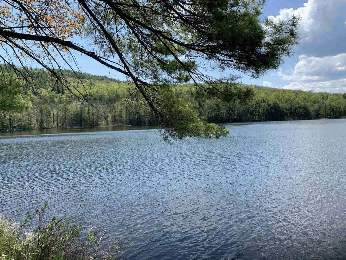 55 Red Fox La. Hague, NY PRICE: $2,200,000 DESCRIPTION: Four season waterfront home w/ 100' of shoreline in Arcady Bay on Northwestern Lake George. Captivating lake views, 2677sqft of living space, cathedral ceilings, 2-story 2-sided fireplace in the great room, 5BRs & 3 full BAs, lakeside screened porch & deck on main floor, lower level w/ family room, wood stove & bluestone patio. Lakeside patio steps down to a U-shaped articulating dock w/ sandy swimming. Arcady Bay's association amenities include a common beach & pavilion, tennis, backboards, basketball court, volleyball courts, shuffleboard, soccer & baseball fields & playground. Just minutes south of the charming hamlet of Hague, w/ easy access to Ti Country Club for golf/dining and Gore Mt for skiing. Walk/jog the Friendship Trail to the Silver Bay YMCA campus. 20 min north of Bolton. SIZE: 1831 square feet BEDROOMS: 5 MLS ID: 202116829 AGENT: Elaine Lawrence BROKERAGE: Sherwood Group, LLC Photos and listing copyright 2021 by Sherwood Group, LLC and associated MLS.