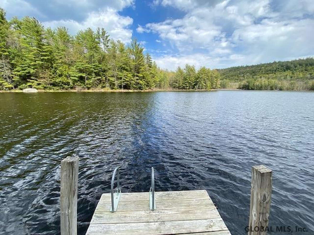 55 Red Fox La. Hague, NY PRICE: $2,200,000 DESCRIPTION: Four season waterfront home w/ 100' of shoreline in Arcady Bay on Northwestern Lake George. Captivating lake views, 2677sqft of living space, cathedral ceilings, 2-story 2-sided fireplace in the great room, 5BRs & 3 full BAs, lakeside screened porch & deck on main floor, lower level w/ family room, wood stove & bluestone patio. Lakeside patio steps down to a U-shaped articulating dock w/ sandy swimming. Arcady Bay's association amenities include a common beach & pavilion, tennis, backboards, basketball court, volleyball courts, shuffleboard, soccer & baseball fields & playground. Just minutes south of the charming hamlet of Hague, w/ easy access to Ti Country Club for golf/dining and Gore Mt for skiing. Walk/jog the Friendship Trail to the Silver Bay YMCA campus. 20 min north of Bolton. SIZE: 1831 square feet BEDROOMS: 5 MLS ID: 202116829 AGENT: Elaine Lawrence BROKERAGE: Sherwood Group, LLC Photos and listing copyright 2021 by Sherwood Group, LLC and associated MLS.