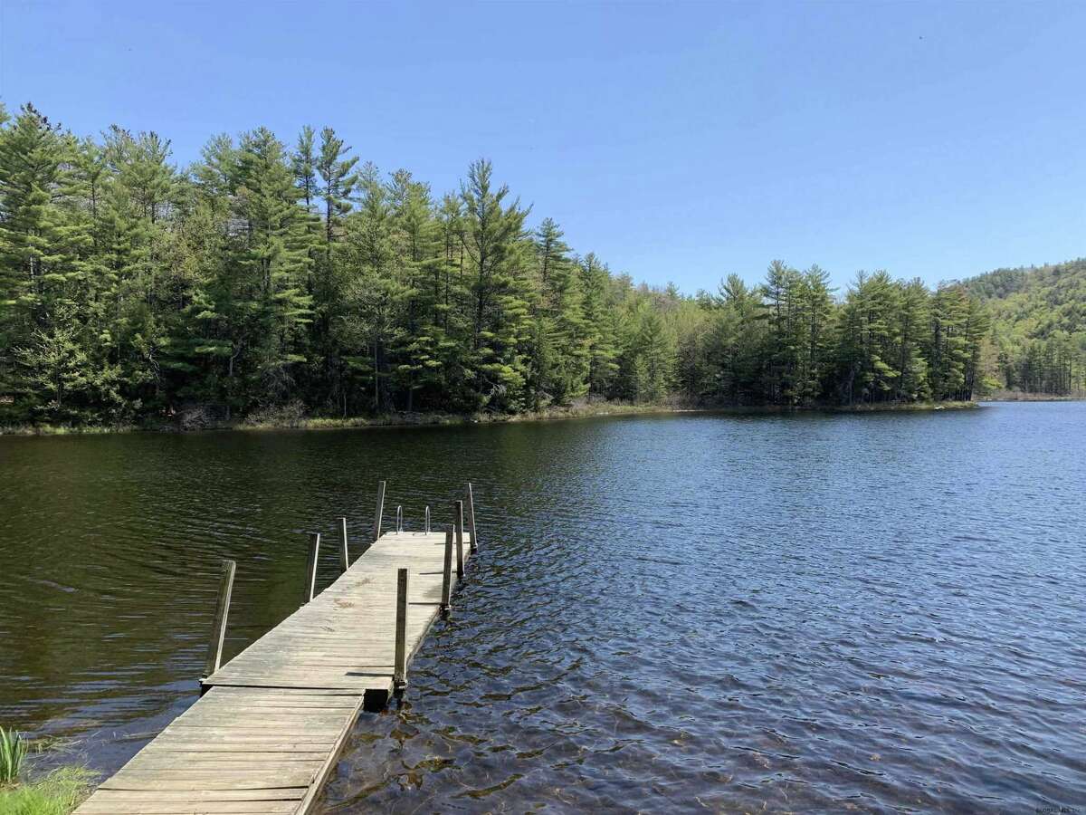 55 Red Fox La. Hague, NY PRICE: $2,200,000 DESCRIPTION: Four season waterfront home w/ 100' of shoreline in Arcady Bay on Northwestern Lake George. Captivating lake views, 2677sqft of living space, cathedral ceilings, 2-story 2-sided fireplace in the great room, 5BRs & 3 full BAs, lakeside screened porch & deck on main floor, lower level w/ family room, wood stove & bluestone patio. Lakeside patio steps down to a U-shaped articulating dock w/ sandy swimming. Arcady Bay's association amenities include a common beach & pavilion, tennis, backboards, basketball court, volleyball courts, shuffleboard, soccer & baseball fields & playground. Just minutes south of the charming hamlet of Hague, w/ easy access to Ti Country Club for golf/dining and Gore Mt for skiing. Walk/jog the Friendship Trail to the Silver Bay YMCA campus. 20 min north of Bolton. SIZE: 1831 square feet BEDROOMS: 5 MLS ID: 202116829 AGENT: Elaine Lawrence BROKERAGE: Sherwood Group, LLC Photos and listing copyright 2021 by Sherwood Group, LLC and associated MLS.