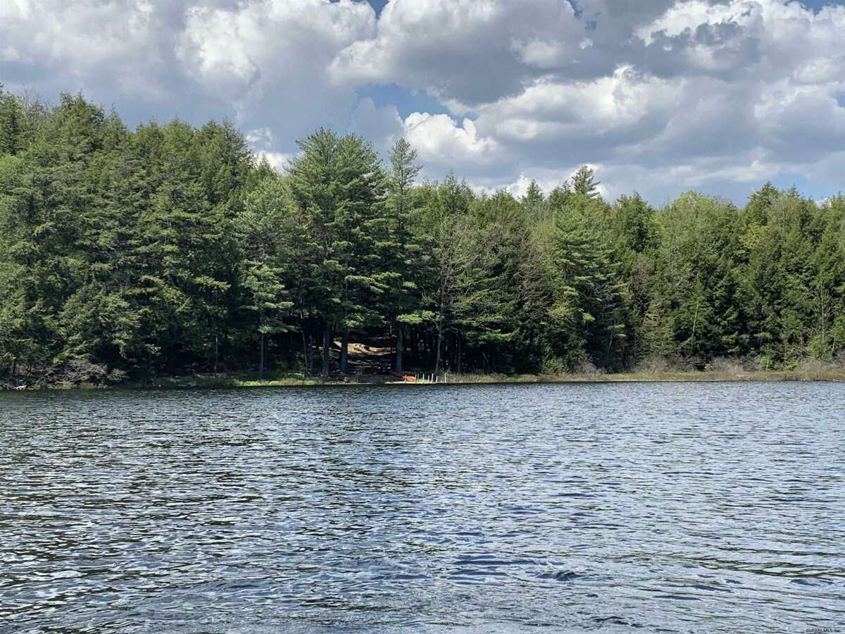 55 Red Fox La. Hague, NY PRICE: $2,200,000 DESCRIPTION: Four season waterfront home w/ 100' of shoreline in Arcady Bay on Northwestern Lake George. Captivating lake views, 2677sqft of living space, cathedral ceilings, 2-story 2-sided fireplace in the great room, 5BRs & 3 full BAs, lakeside screened porch & deck on main floor, lower level w/ family room, wood stove & bluestone patio. Lakeside patio steps down to a U-shaped articulating dock w/ sandy swimming. Arcady Bay's association amenities include a common beach & pavilion, tennis, backboards, basketball court, volleyball courts, shuffleboard, soccer & baseball fields & playground. Just minutes south of the charming hamlet of Hague, w/ easy access to Ti Country Club for golf/dining and Gore Mt for skiing. Walk/jog the Friendship Trail to the Silver Bay YMCA campus. 20 min north of Bolton. SIZE: 1831 square feet BEDROOMS: 5 MLS ID: 202116829 AGENT: Elaine Lawrence BROKERAGE: Sherwood Group, LLC Photos and listing copyright 2021 by Sherwood Group, LLC and associated MLS.