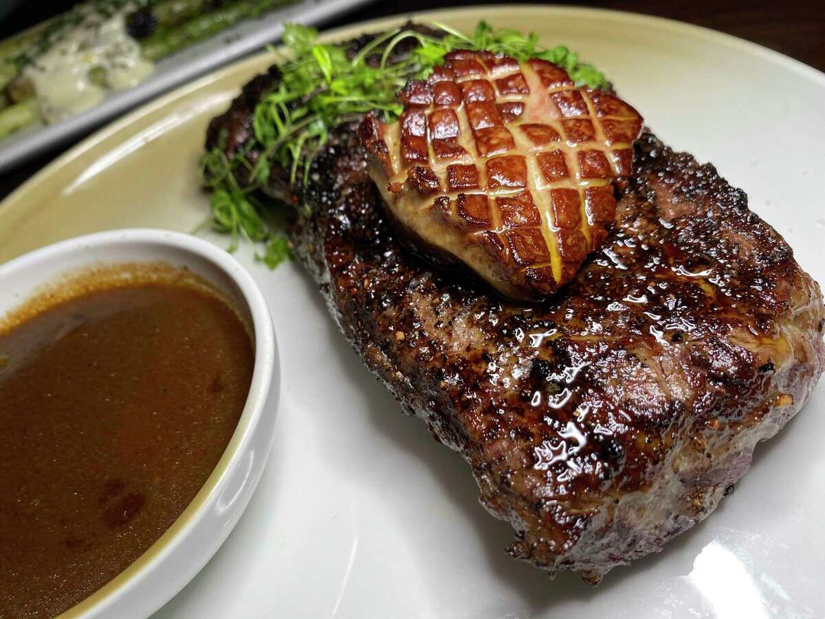 A 16-ounce New York strip steak comes with chile pequín au poivre sauce, with the option of adding foie gras, at Landrace, the restaurant by chef Steve McHugh at the Thompson San Antonio - Riverwalk hotel.