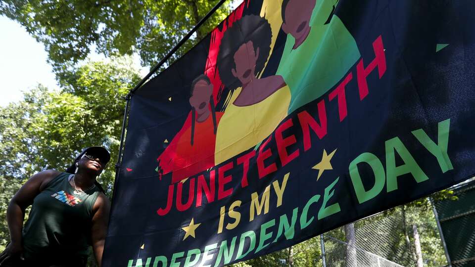 Tasia Payne hangs a Juneteenth flag during a Juneteenth celebration at Kasmiersky Park, Saturday, June 19, 2021, in Conroe. Juneteenth, which recently became a federal holiday after being signed into law this week by President Joe Biden, recognizes the end of slavery in the United States. It is held on June 19, the anniversary of the announcement of emancipation for enslaved people in Texas in 1865, nearly three years after President Abraham Lincoln signed the Emancipation Proclamation.