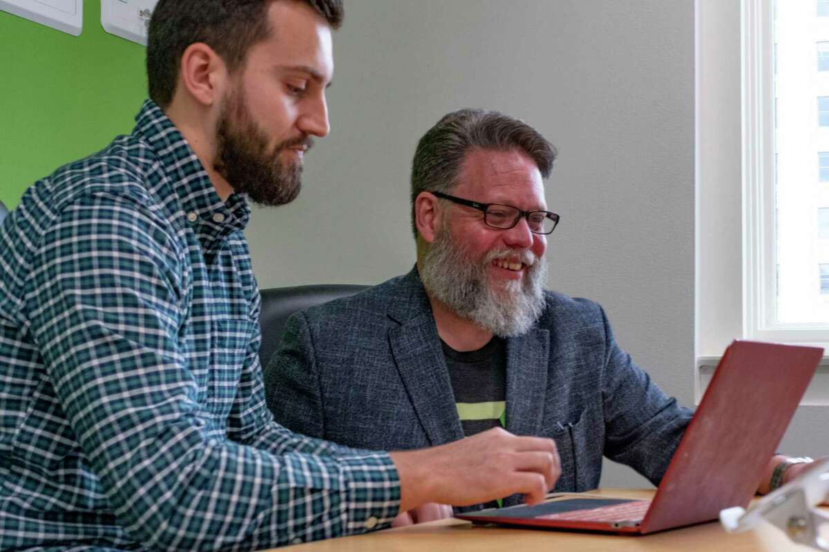 Jason Straughan, right, founder and CEO of CodeUp, sits with Stuart Rowe, admiissions manager, at CodeUp on Wednesday, July 7, 2021.