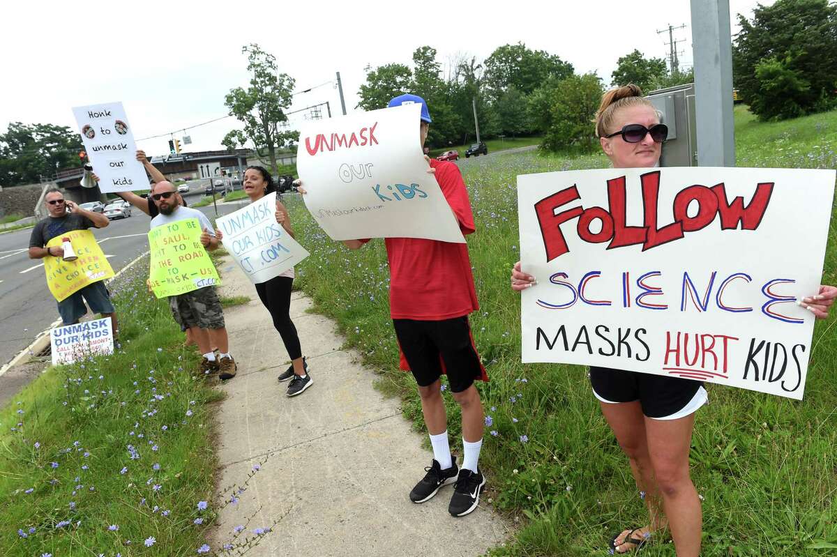 Jamie Kovecses, right, of Branford joins in an anti-mask rally for children in Branford July 7, 2021.