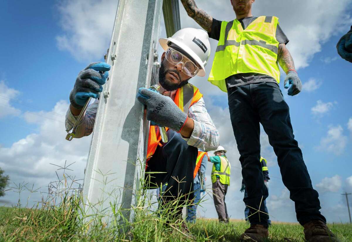 Quinton Buntin tightens a bolt while installing apparatus that holds solar panels during a training class on installing the solar infrastructure, Tuesday, May 11, 2021, at a solar farm south of El Campo. Buntin has been working as a mechanic, but sees the solar energy industry as the job of the future. "You either get with it, or get behind," said Buntin. Lone Star College has partnered with Workrise to provide free training for workers who want to work in the solar industry.