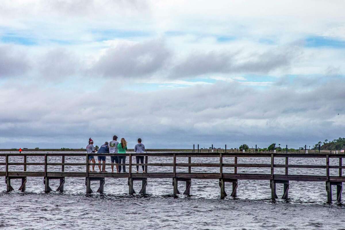 STEINHATCHEE, FL - JULY 07: Sightseers look at breaks in the clouds after Tropical Storm Elsa made landfall nearby on July 7, 2021 in Steinhatchee, Florida. Storm warnings remain in effect for parts of Florida's west coast as Tropical Storm Elsa made landfall on Wednesday morning. After hitting Cuba on Monday, causing flooding and mudslides, Elsa is expected to bring strong winds and rain as it heads north in the coming days. (Photo by Mark Wallheiser/Getty Images)