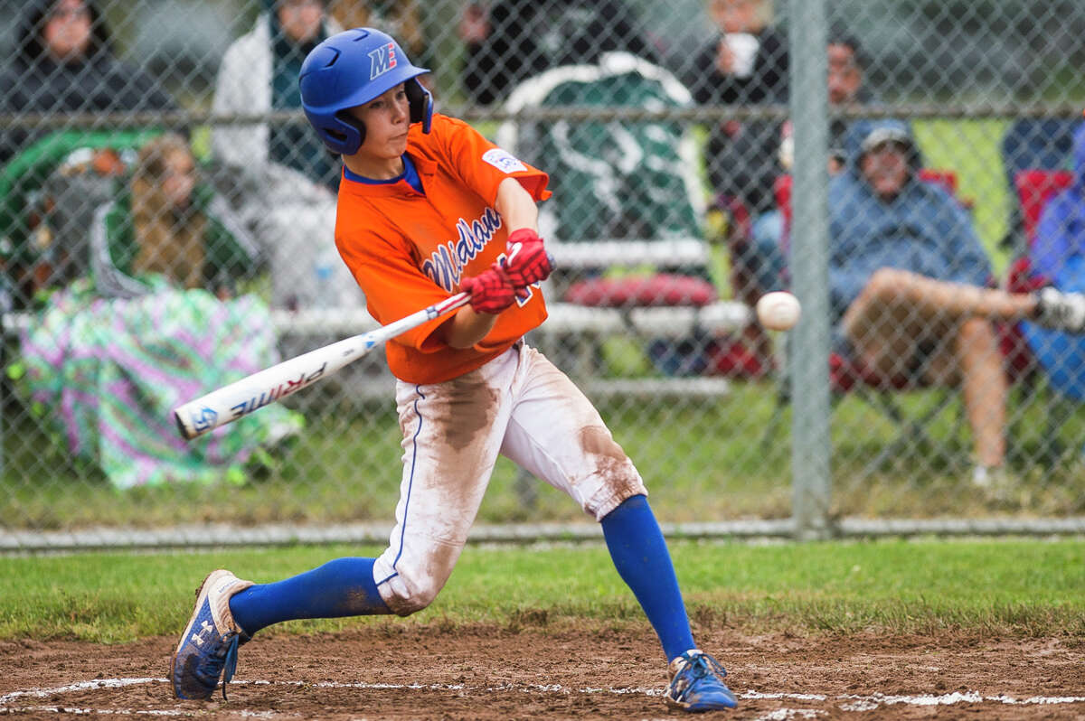 Midland's Eli Kell swings on a pitch during a Junior League district final against Freeland Thursday, July 8, 2021 at Plymouth Park in Midland. (Katy Kildee/kkildee@mdn.net)