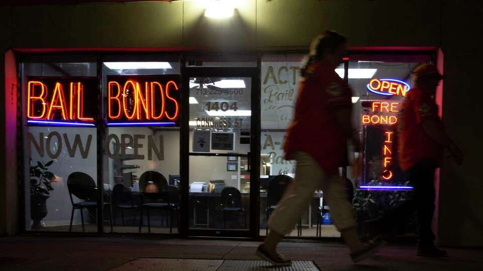 Action Bail Bonds is photographed at night Wednesday, June 30, 2021, in downtown Houston. Defendants usually pay bail bonds companies 10 percent of their surety bond amount to get out of jail.