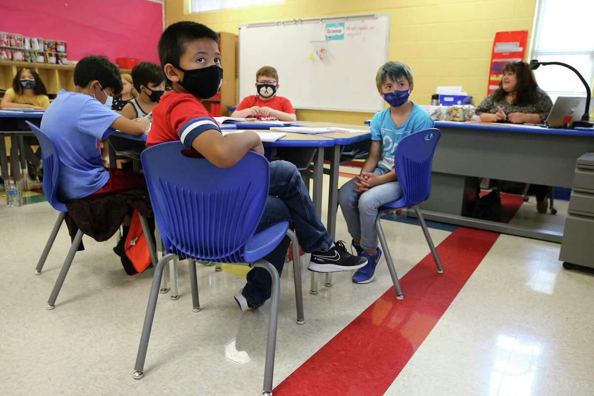 Coker Elementary School third grade students like Manny Gonzales, foreground, opt to wear a mask while attending summer school. Thirty-one Texas legislators have sent a letter to Gov. Greg Abbott and Texas Education Agency Commissioner Mike Morath asking them to reverse the current ban on mask mandates in schools.
