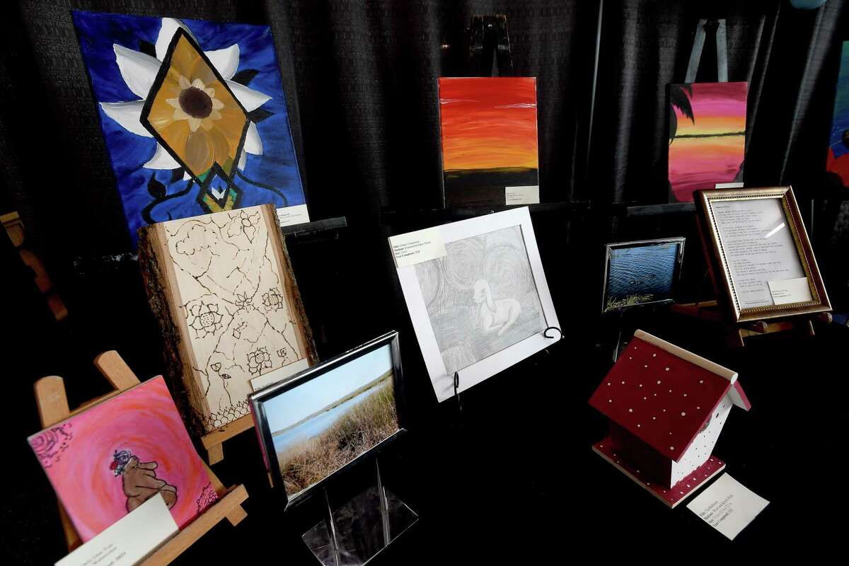 A table filled with art done by survivors of child sex trafficking was on display at the Harvest House booth during the Harvest House Birthday Block Party at The Event Centre Thursday. Multiple local vendors and churches offering free carnival style games, along with entertainment and food trucks filled the venue. Photo made Thursday, July 8, 2021 Kim Brent/The Enterprise