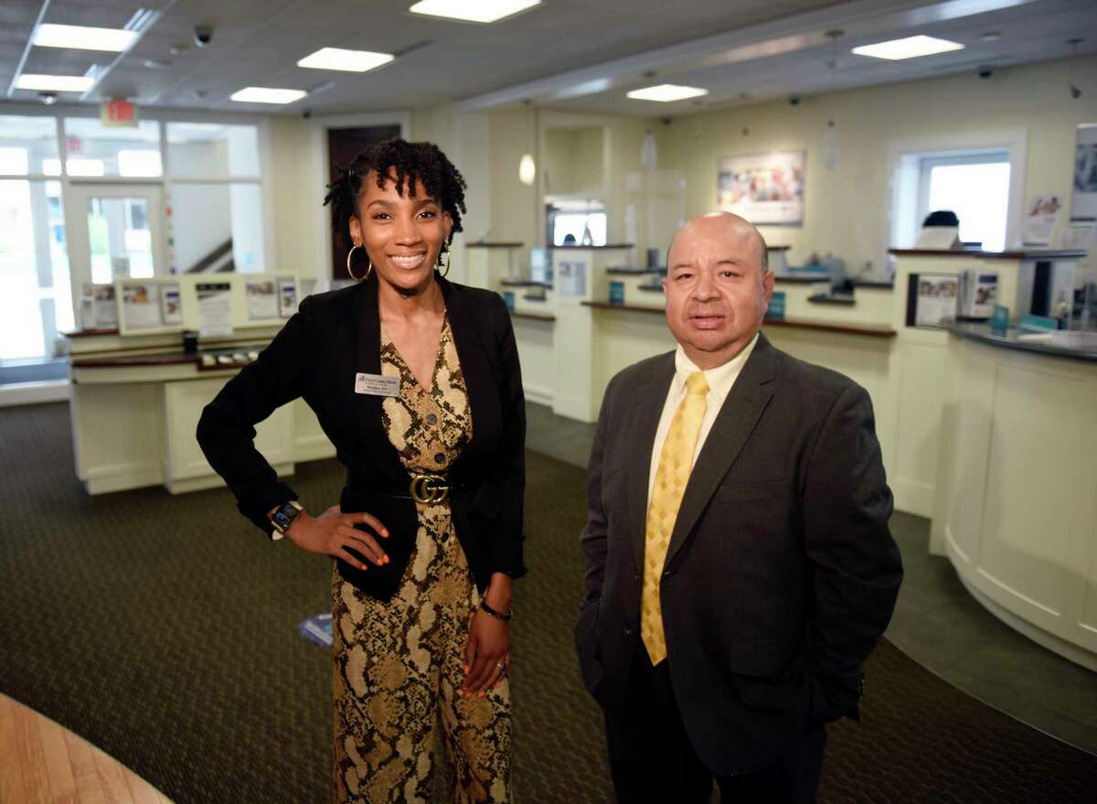 Assistant Branch Manager Monique Gist and Branch Manager Camilo Duque Jr. pose at First County Bank in Stamford, Conn. Thursday, July 8, 2021.