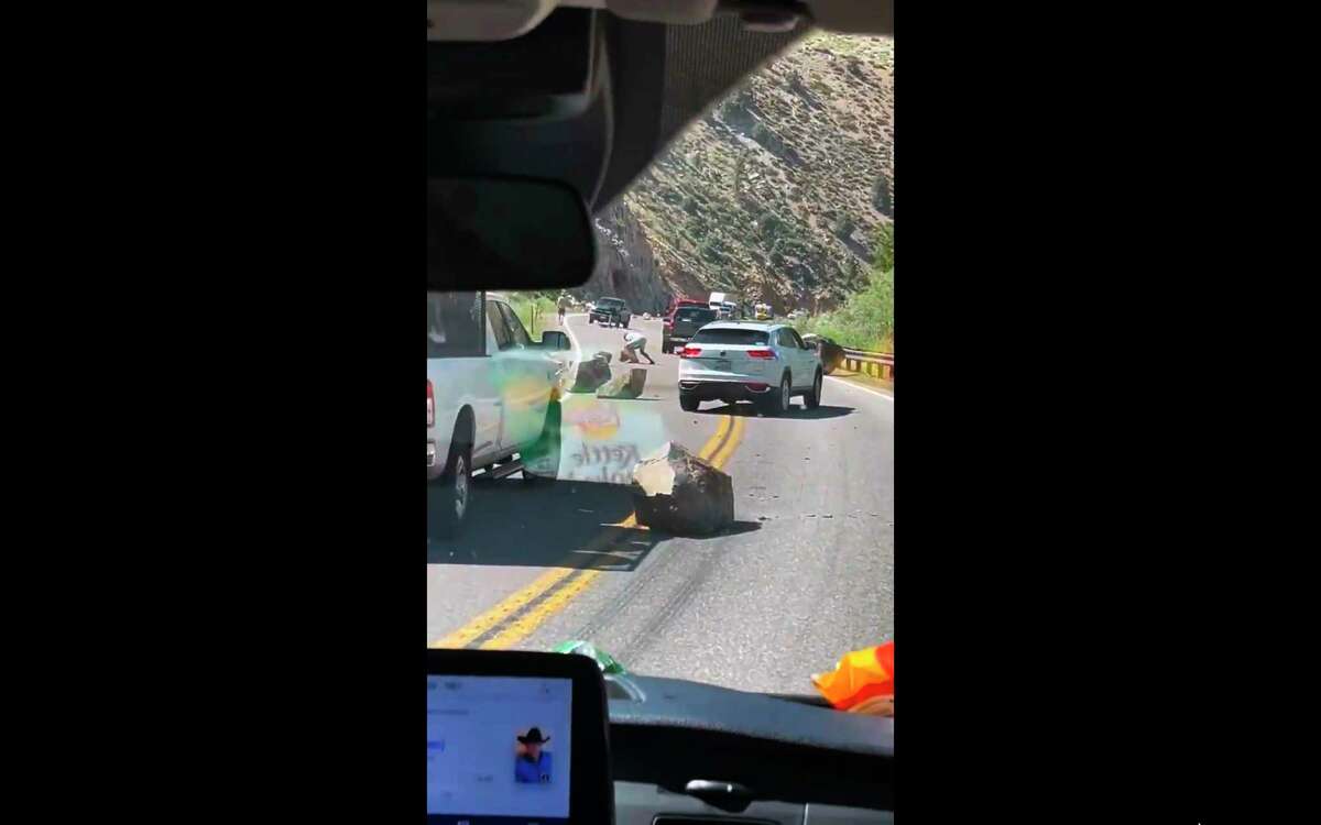 This image from video provided by Brett Durrant shows boulders blocking U.S. Route 395 near the California state line with Nevada, after an earthquake Thursday.