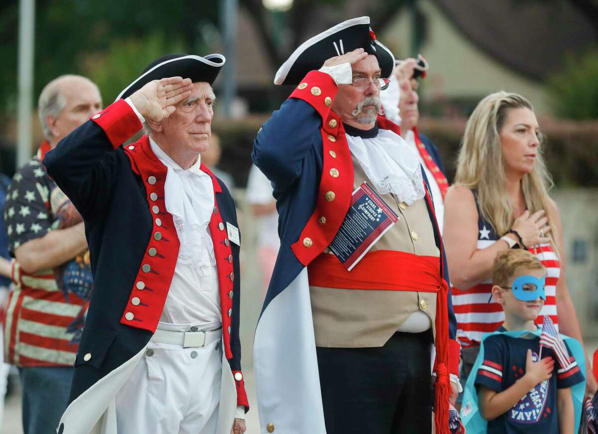 David Underdown and David Hamaker with Sons of the American Revolution salute as the national anthem is played as the Conroe Symphony plays the national anthem during a concert at Heritage Place Park, Saturday, July 3, 2021, in Conroe. The Conroe Symphony Orchestra patriotic performance is Saturday night at 8 p.m.