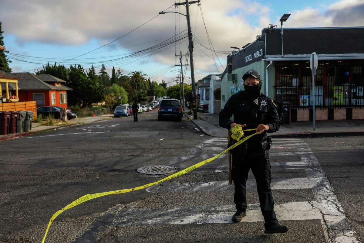 Oakland police Officer L. Mai collects crime tape after a shooting investigation in June. California officials recently released data showing that homicides in the state were up 31% in 2020. But the reasons for the spike — the largest percentage increase in years — are still unclear.