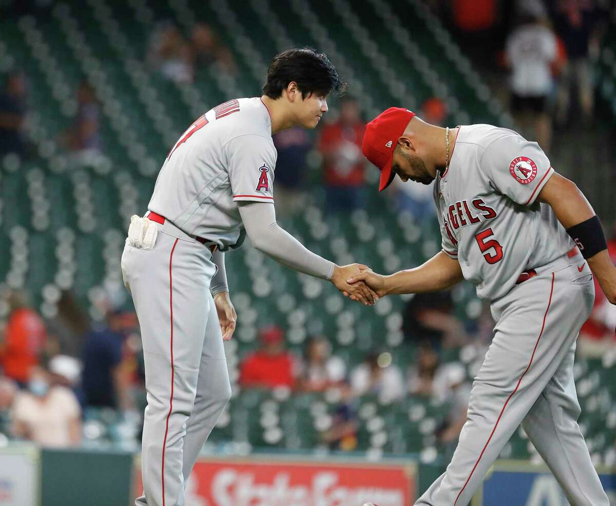 Los Angeles Angels Shohei Ohtani (17) congratulates Los Albert Pujols (5) after beating the Houston Astros 4-2 after an MLB baseball game at Minute Maid Park, Sunday, April 25, 2021, in Houston.