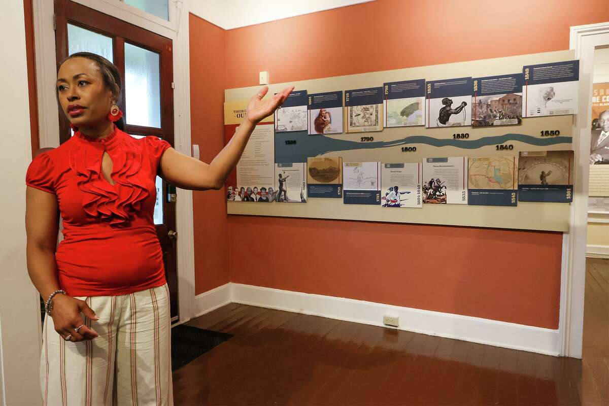 Program director Heather Williams talks about a timeline display on the wall showing contributions by African Americans to the region's history at the new home of the San Antonio African American Community Archive and Museum (SAAACAM) in the Southwest corner of La Villita Historic Arts Village at 218 A. Presa on Friday, July 9, 2021. The museum has a timeline display, archives and exhibits about local Black history and leaders who have worked for civil rights progress.