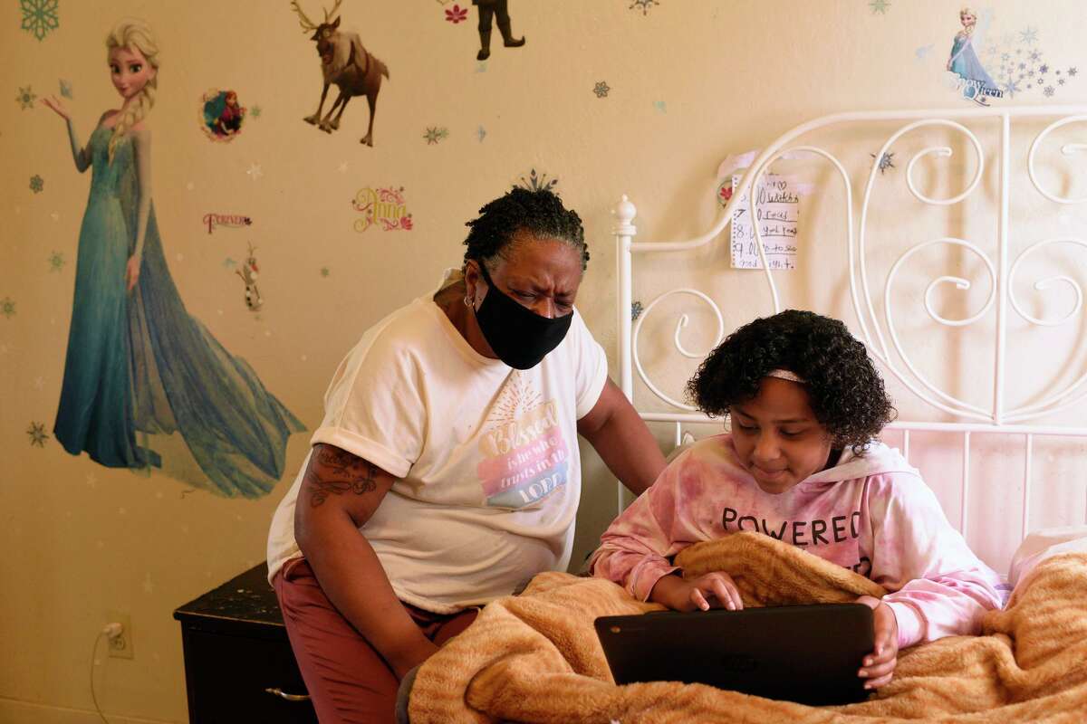 Rodeo resident Felicia Carter, shown helping her granddaughter, Daeshanay Gospel, 9, with remote schoolwork, had her unemployment benefits inexplicably stop in December.