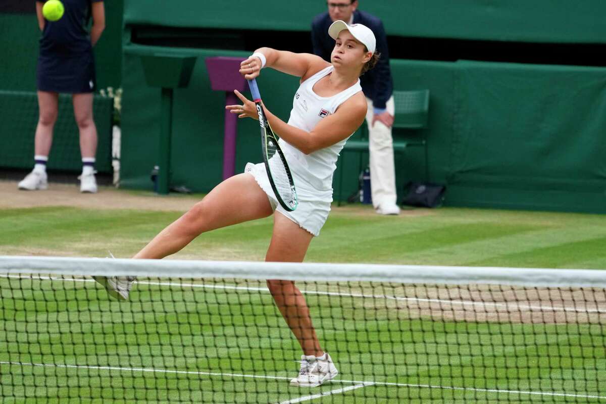 Australia's Ashleigh Barty plays a return to Czech Republic's Karolina Pliskova during the women's singles final match on day twelve of the Wimbledon Tennis Championships in London, Saturday, July 10, 2021.
