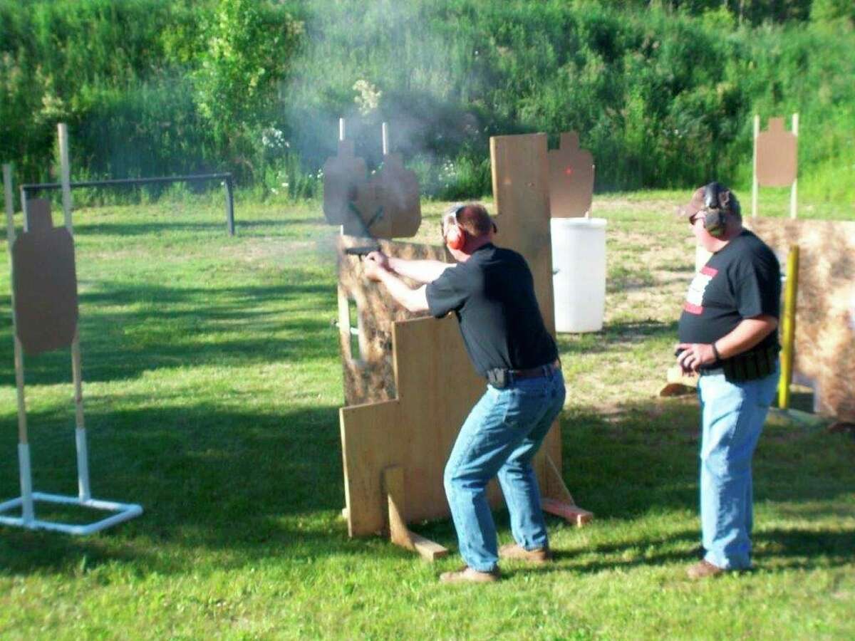 Competitive "action" pistol shooting is often a timed event, as was the case with the competition pictured here. (Tom Lounsbury/Hearst Michigan)
