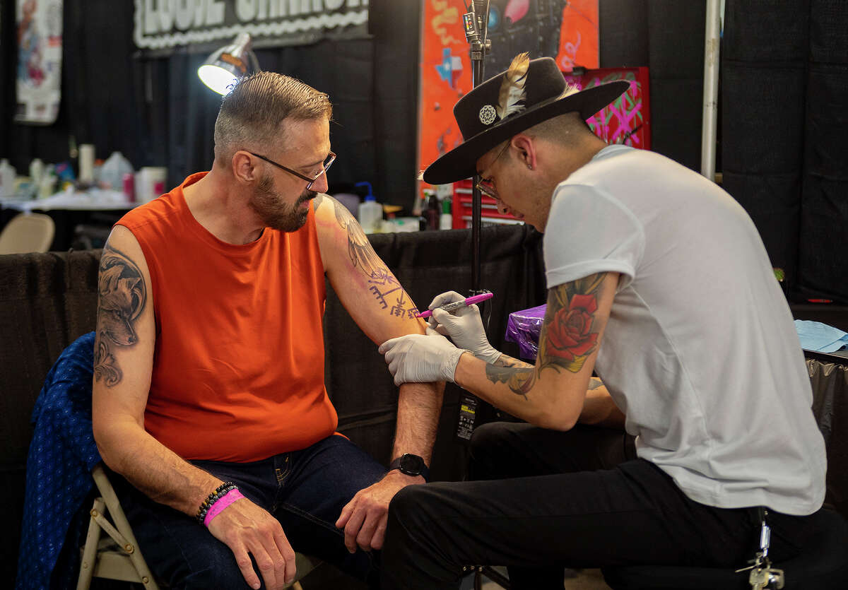 Tattoo artist Andrew Duran prepares Marty Jones for his tattoo Saturday, July 10, 2021, at the Webb County Pavilion during the Por Vida International Tattoo Art Festival.