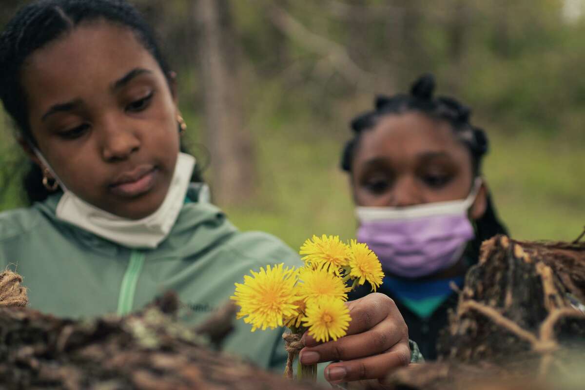 Children's Community School 6th Graders Jacely and Kayanna put finishing touches on their fort at Macricostas Preserve.