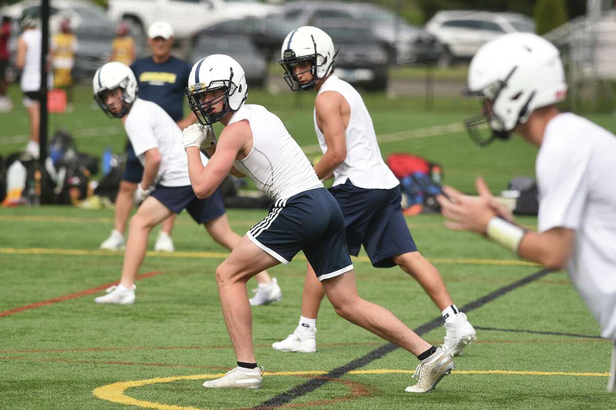 Staples receivers wait for the ball to be snapped to quarterback Ryan Thompson during Day 2 of the Grip It and Rip It football tournament in New Canaan on Saturday, July 10, 2021.