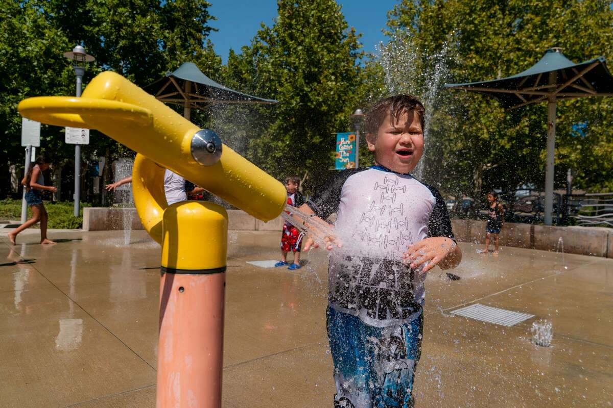 Hot temperatures are in the Bay Area forecast on Tuesday. In this file photo, Mark Campoverde, 7, sprays himself with a water cannon at Brentwood City Park in Brentwood, Calif., on Saturday, July 10, 2021. 