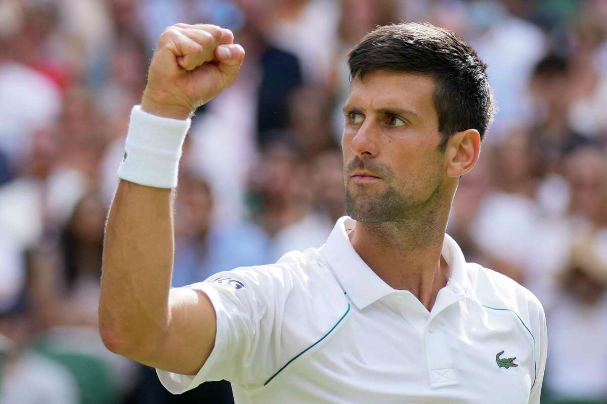 Serbia's Novak Djokovic celebrates after winning a point against Italy's Matteo Berrettini during the men's singles final on day thirteen of the Wimbledon Tennis Championships in London, Sunday, July 11, 2021.