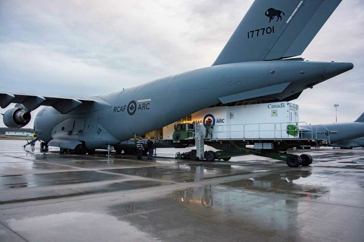 An Aeromedical Biocontainment Evacuation System (ABES) is loaded on a Canadian Armed Forces CC-117 Globemaster at 8 Wing, Trenton, Ontario on April 11, 2021 in preparation for its first mission. Knight Aerospace at Port San Antonio builds these special medical modules for aircraft.