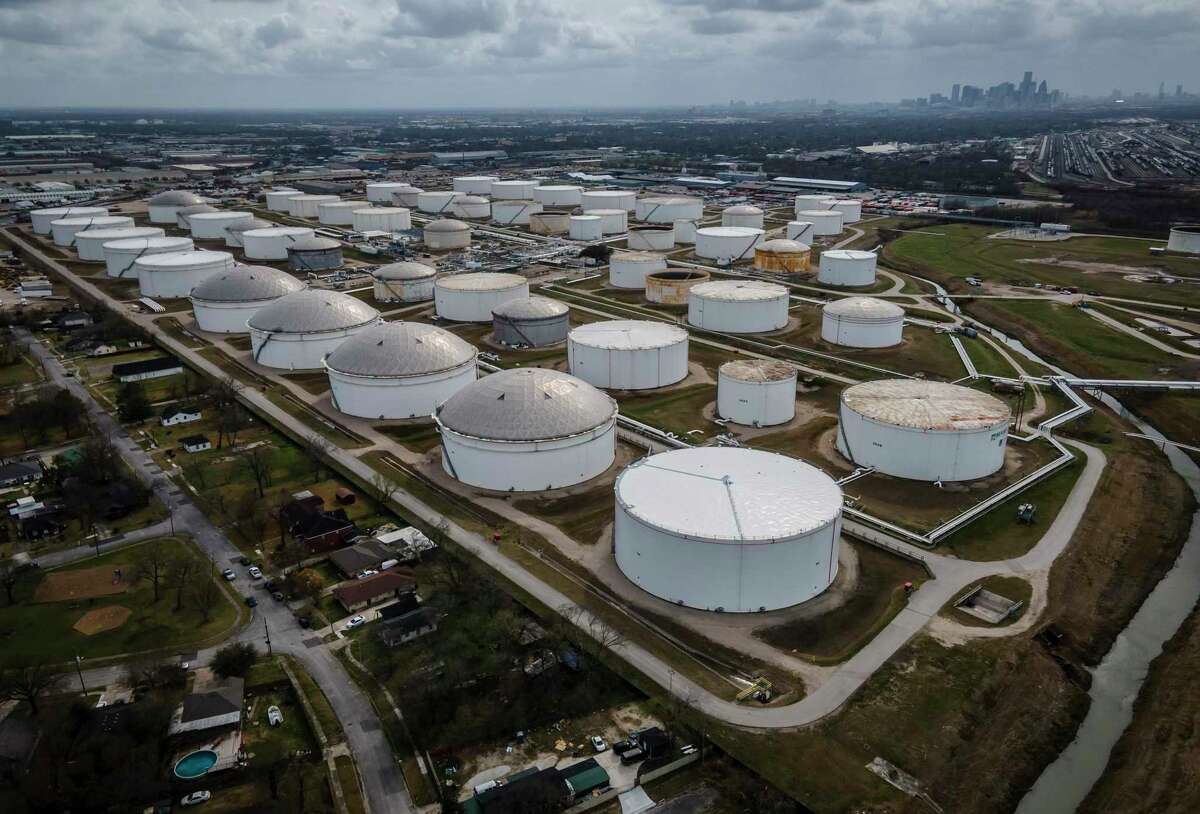 Storage tanks dot the landscape adjacent to a neighborhood northeast of downtown Houston on Thursday, March 11, 2021.