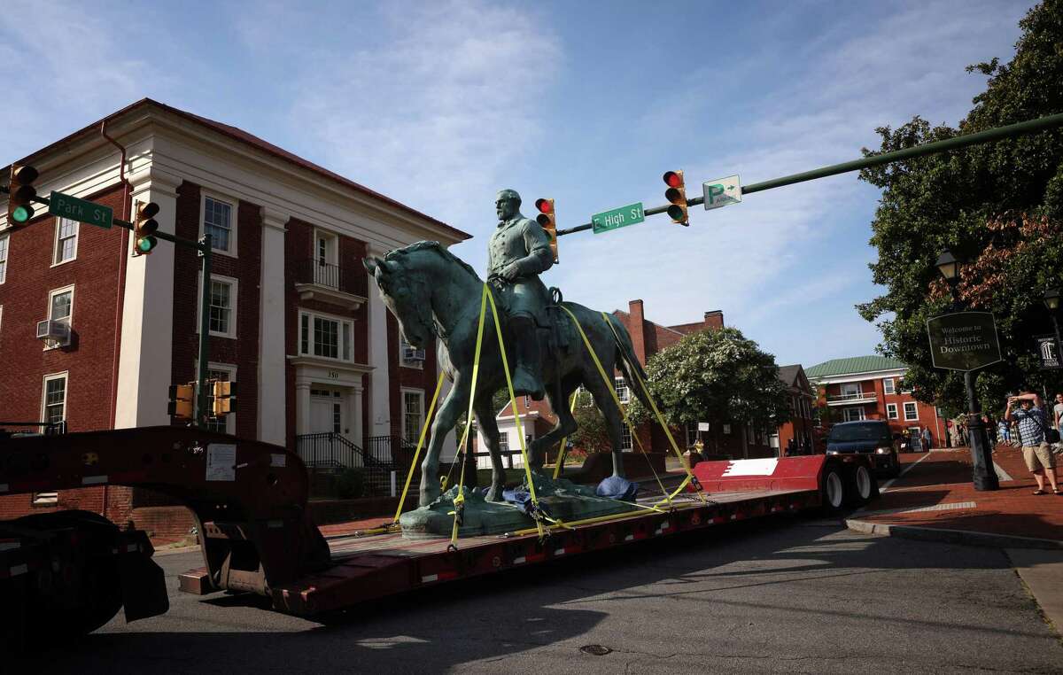 A flatbed truck carries a statue of Confederate General Robert E. Lee from the Market Street Park July 10, 2021, in Charlottesville, Virginia. Initial plans to remove the statue four years ago sparked the infamous “Unite the Right” rally where 32 year old Heather Heyer was killed. A statue of Confederate General Thomas "Stonewall" Jackson in the Charlottesville and Albemarle County Courthouse Historic District is also scheduled to be removed this weekend. (Photo by Win McNamee/Getty Images)