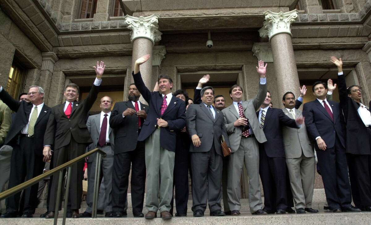 Texas House Democrats wave to supporters gathered on the south steps of the Capitol in Austin, Texas Friday, May 16, 2003. The Democrats, who have been in Oklahoma since Monday in order to prevent quorum in the House and stop a controversial redistricting bill, were welcomed home after their arrival early Friday morning. (AP Photo/Kelly West)
