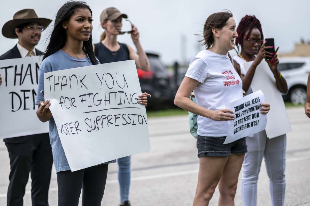 Supporters for Texas Democrats stand outside the Austin Bergstrom International Airport on July 12, 2021 in Austin, Texas. Texas Democrats fled the state to prevent a quorum after protesting SB7, a voting protection bill that Democrats have criticized as being too restrictive. (Photo by Sergio Flores/Getty Images)